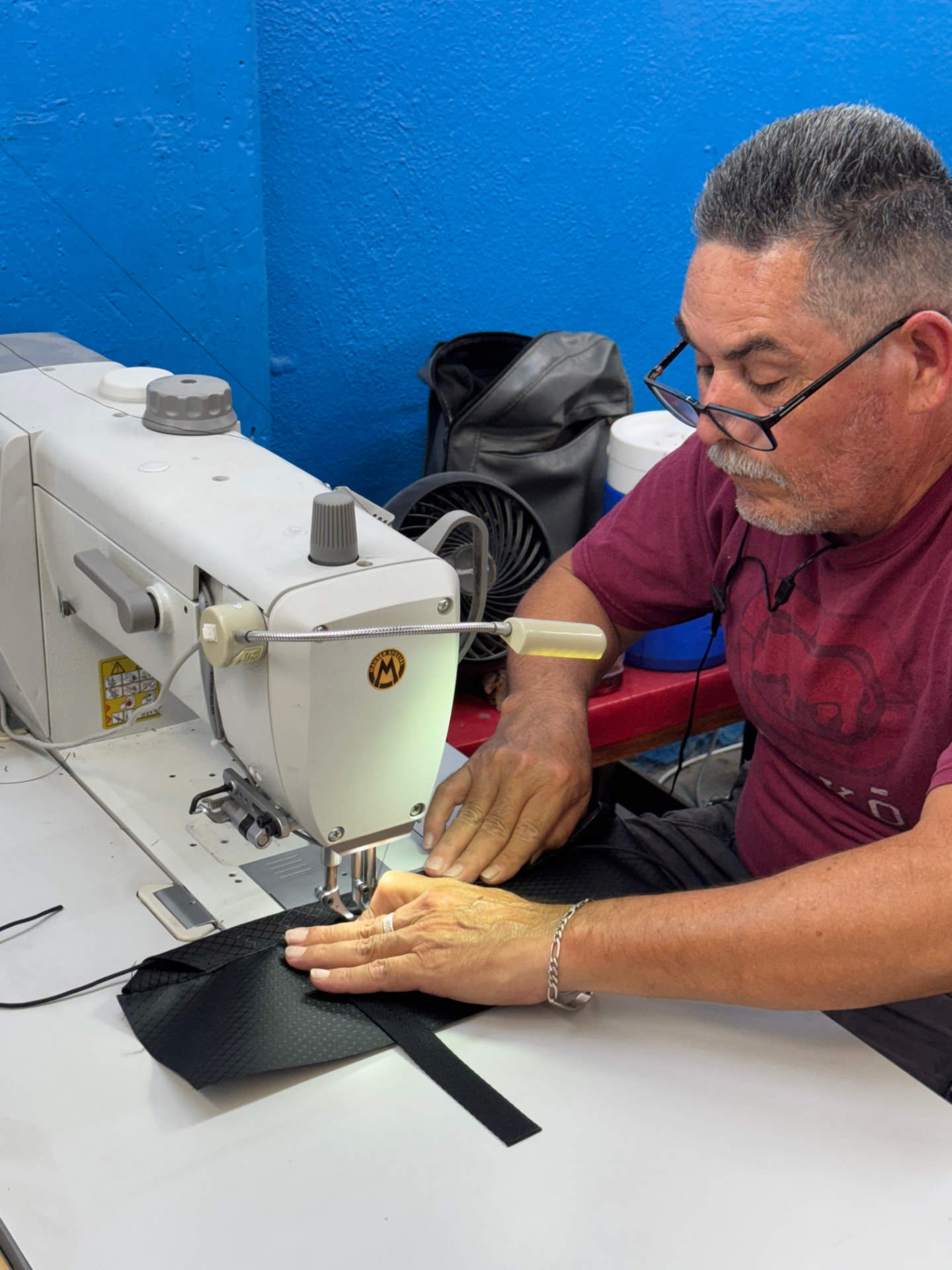 Experienced operator sewing technical fabric at a walking-foot machine in Tecate